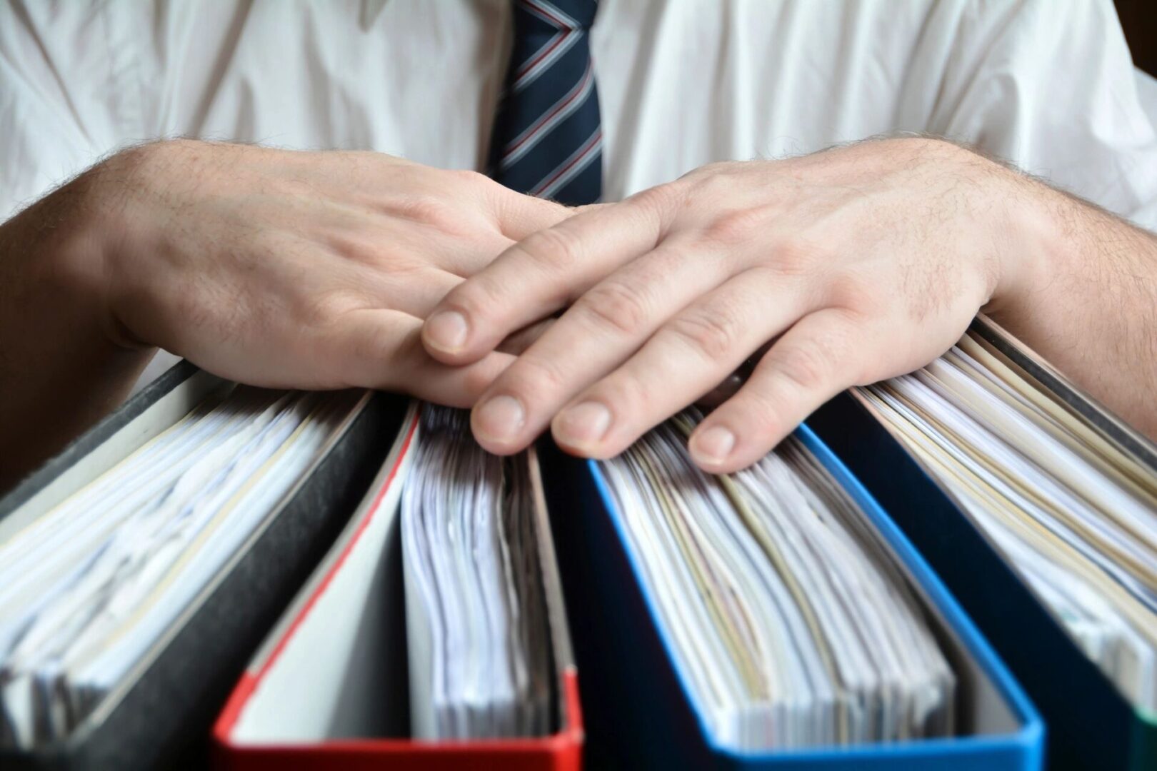 A person in a tie is holding some papers